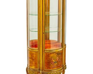 1232
Late 19th/early 20th century
A Transitional Louis XV/XVI-Style Vernis Martin Lighted Vitrine Cabinet
The single door wood carcass with a central painted panel depicting a courting couple to the door front, opening to reveal two glass display shelves and a velvet upholstered storage cubby, gilt bronze mounted throughout, and surmounted by an inset marble top and a brass reticulated gallery rail; set upon four cabriole legs, electrified
62.75" H x 27.25" W x 16.25" D 
Estimate: $600 - $800