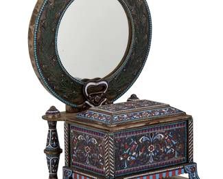 1241
Late 19th/early 20th century; Moscow Russia
A Russian Cloisonné Enamel Vanity Box
Stamped for maker to the right side in Cyrillic
In the style of Gustav Klingert, the silver footed casket with a hinged lid and locking mechanism, surmounted by a circular mirror within an ornate frame and set upon a metal plinth base, all with enameled scrollwork, avian, and foliate motifs
17" H x 10.25" W x 10" D
Estimate: $1,200 - $1,800