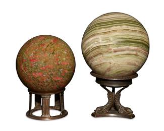 1285
20th century
Two Petrified Wood Spheres
Comprising two semi-precious stone spheres, one striated in tones of green and brown and the other green mottled with flecks of red and grey, each set upon a cast metal stand decorated with Neoclassical motifs, 2 pieces
Larger with stand: 12.5" H x 7" Dia.; smaller with stand: 10" H x 6" Dia.
Estimate: $600 - $800