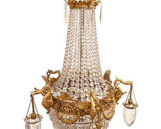 1342
Early 20th century
A French Empire-Style Draped Chandelier
The fourteen-light gilt-bronze chandelier with all-over wreath and rocaille motifs and featuring five full-scale figural swans, each with suspended cut lead glass shades hanging from three chains and all-over cascading prismatic tear drops and strands of faceted glass beading, electrified
50" H x 28" Dia.
Estimate: $2,000 - $4,000