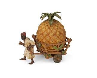 1347
Early 20th century
An Austrian Cold-Painted Bronze Figural Ink Well
Appears unmarked
Th cast bronze ink well depicting a male figure pulling a bamboo, wheeled cart with a singular large pineapple, which opens via a hinged lid to reveal the ink reservoir within, all painted in true-to-life hues
6.5" H x 4" W x 6.25" D
Estimate: $800 - $1,200