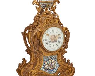 1348
19th century
A French Louis XV-Style Gilt-Bronze Mantel Clock
Marked to movement: JT / 1575
The mantel pendulum clock with two-train movement, black Roman and Arabic numerals on the enameled metal dial, set in a bronze case with allover rocaille and foliate decorations, accented with champlevé enameled foliate designs to the recto and finial
23" H x 12.75" W x 6" D
Estimate: $1,000 - $2,000
