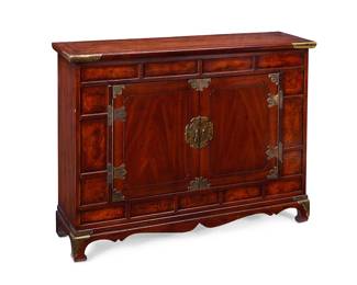 1365
Mid/late 20th century; Spruce Pine, NC
A Henredon Chinoiserie Mahogany Cabinet
With a paper label to the verso: Henredon Furniture Industries, Inc.
In the style of a Korean Bandaji chest, the double-doored cabinet, accented with foliate brass hardware including corner reinforcements and pulls, opening to reveal interior shelving, and set upon four Chinoiserie-style carved wood legs
32" H x 43" W x 12.5" D
Estimate: $500 - $700
