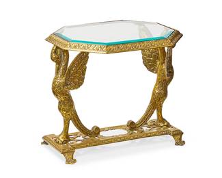 1380
Mid-20th century
A Hollywood Regency Brass Side Table
The table featuring an octagonal beveled glass top set into a cast brass frame supported by opposing sculptural swan-like birds on a rectangular base with openwork scrolled and rocaille designs atop four trefoil-form feet
19.5" H x 25" W x 17.25" D
Estimate: $400 - $600
