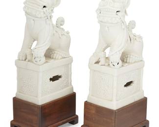 1399
Republic Period 1912-1949 or later
A Pair Of Chinese Dehua-Style Porcelain Guardian Lions
Each appear unmarked
The glossy white ceramic lions, each usually depicted with both the typical attributes of a male and female pairing, and set upon a porcelain pedestal decorated with cherry blossoms in relief; each on a wood plinth base, 4 pieces
Each on base: 16.25" H x 4.25" W x 6.25" D approximately
Estimate: $1,000 - $1,500