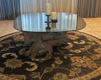 Glass table top on driftwood base. The area rug is available as well