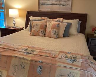 Another view of the king bed; framed artwork, linens, and lamp