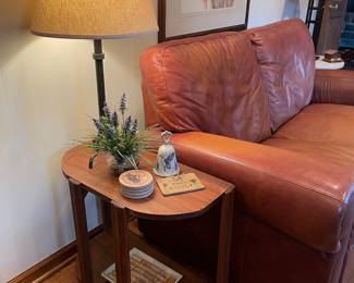 Another view of the leather loveseat side table and iron lamp and more