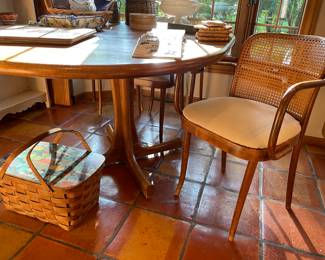 Single pedestal oak kitchen table with 2 leaves;  and 4 cane-back armchairs with upholstered seats