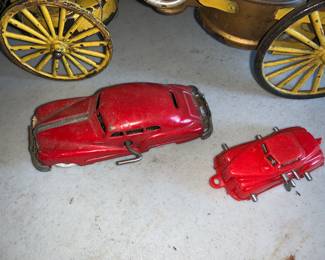 Vintage wind up tin cars. 
