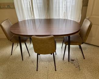 Kitchen table has 4 Chairs. Leaf is inserted.