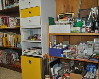 Large collection of cookbooks and cook booklets, recipe files, art supplies, paints - acrylic and oil, pastels, stationery supplies, stamps, scissors, art and sketch books, brushes, canvasses, two-stack drawer/shelf unit full of office supplies.