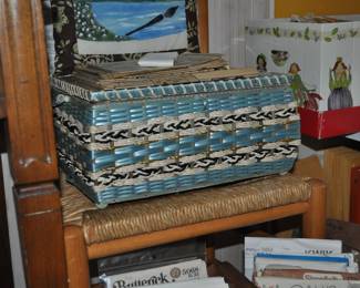 One of several sewing caddies, rush seat chair, sewing items, patterns.