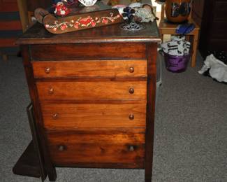 This room is enormous!  This half is filled with children's books, games and puzzles, office supplies, tole painting supplies, Ikea storage containers, craft supplies, dressers, tall multi-drawer cabinet, printer, craft kits, boxes, frames, antique children's desks, red/white/blue decorations, bee collectibles, pails, rocking horses, children's furniture, dining chairs, stuffed animals, baskets, and sooo much more!