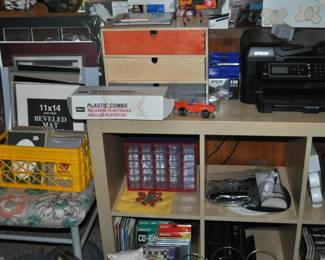 This room is enormous!  This half is filled with children's books, games and puzzles, office supplies, tole painting supplies, Ikea storage containers, craft supplies, dressers, tall multi-drawer cabinet, printer, craft kits, boxes, frames, antique children's desks, red/white/blue decorations, bee collectibles, pails, rocking horses, children's furniture, dining chairs, stuffed animals, baskets, and sooo much more!