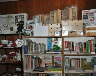 This room is enormous!  This half is filled with children's books, games and puzzles, office supplies, tole painting supplies, Ikea storage containers, craft supplies, dressers, tall multi-drawer cabinet, printer, craft kits, boxes, frames, antique children's desks, red/white/blue decorations, bee collectibles, pails, rocking horses, children's furniture, dining chairs, stuffed animals, baskets, and sooo much more!