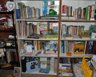 This room is enormous!  This half is filled with children's books, games and puzzles, office supplies, tole painting supplies, Ikea storage containers, craft supplies, dressers, tall multi-drawer cabinet, printer, craft kits, boxes, frames, antique children's desks, red/white/blue decorations, bee collectibles, pails, rocking horses, children's furniture, dining chairs, stuffed animals, baskets, and sooo much more!