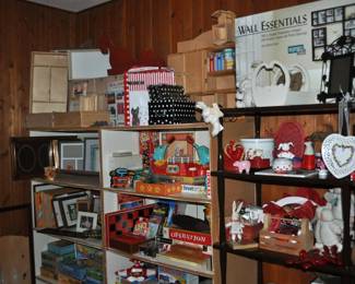 This room is enormous!  This half is filled with children's books, games and puzzles, office supplies, tole painting supplies, Ikea storage containers, craft supplies, dressers, tall multi-drawer cabinet, printer, craft kits, boxes, frames, antique children's desks, red/white/blue decorations, bee collectibles, pails, rocking horses, children's furniture, dining chairs, stuffed animals, baskets, and sooo much more!