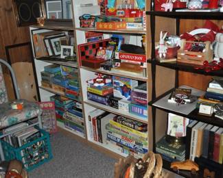 This room is enormous!  This half is filled with children's books, games and puzzles, office supplies, tole painting supplies, Ikea storage containers, craft supplies, dressers, tall multi-drawer cabinet, printer, craft kits, boxes, frames, antique children's desks, red/white/blue decorations, bee collectibles, pails, rocking horses, children's furniture, dining chairs, stuffed animals, baskets, and sooo much more!