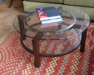 Round glass coffee table. and area rug.