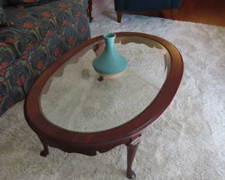 Oval wood and glass coffee table.
