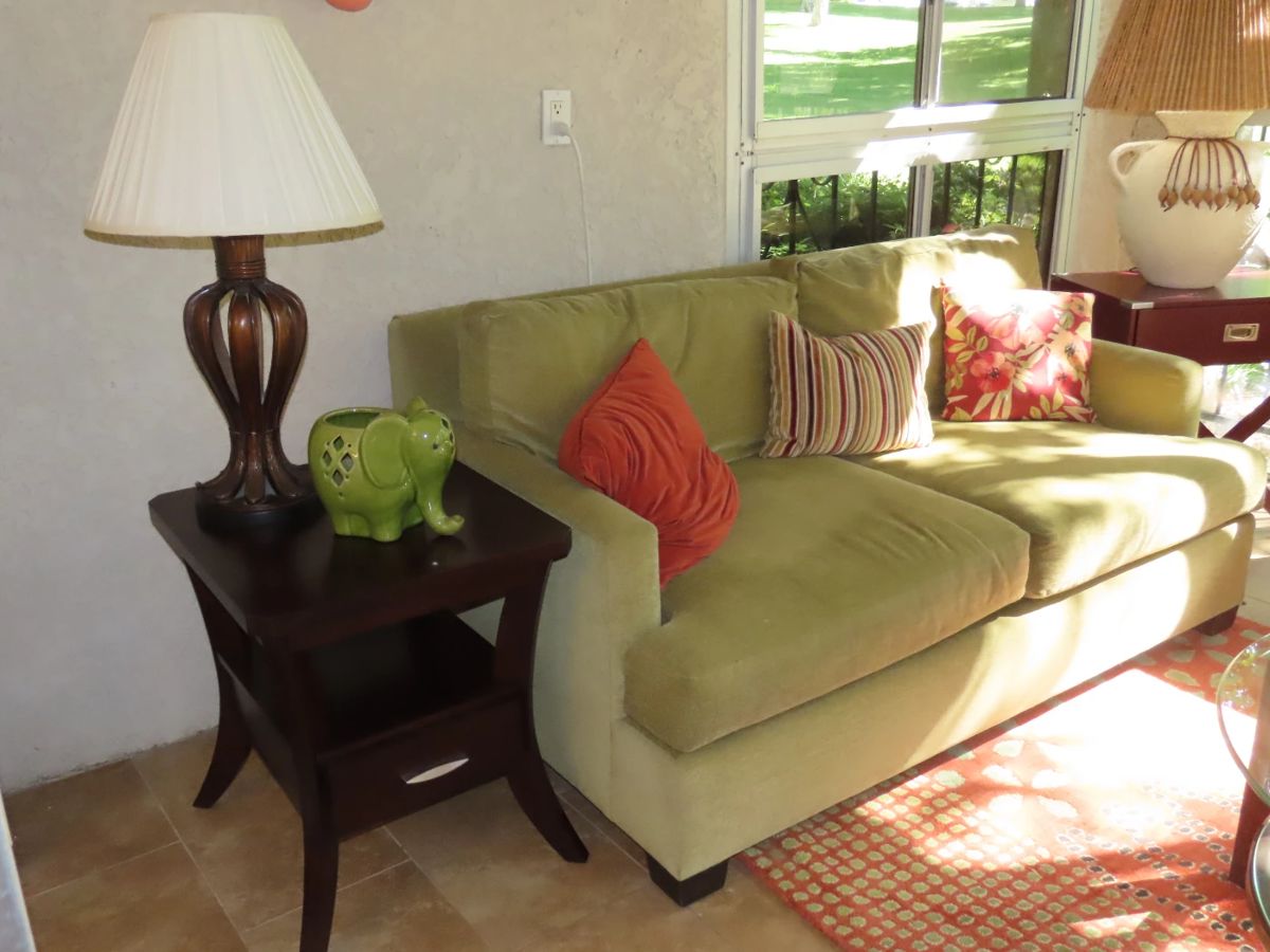 One of two matching loveseats and end tables.