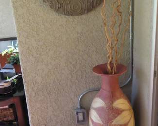 Round mirror and large vase.