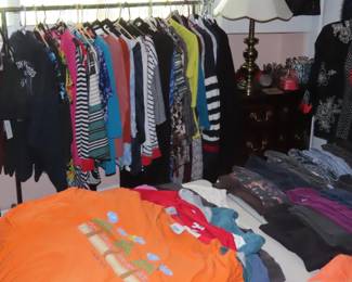 Racks and tables of ladies clothing. XL, XXL.