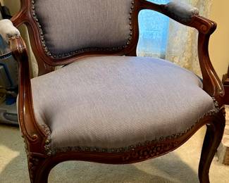 Blue upholstered antique arm chair with carved cherry wood trim with grommets 25” x 18” x 16” floor to seat 
$115