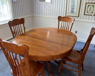 Lovely dining table with six chairs and leaf.