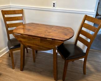 Sweet kitchen table with two chairs with leather seats. Fairly new set!
