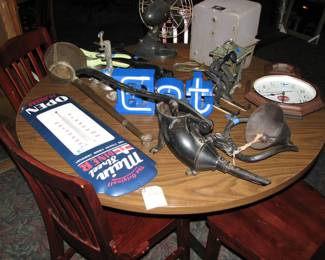Cast iron bell, sausage press, "EAT" sign, metal advertising thermometer