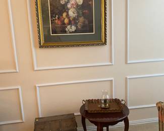 Floral artwork, small chest and end table