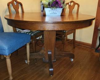 1940's Oak Dining Table with 3 leaves.  2 blue upholstered dining chairs.  4 antique wood dining chairs with 1 matching arm chair. 