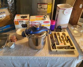Pressure cooker, set of flatware, fondue set, Rubbermaid storage set (never opened), old Zinc jar lids....