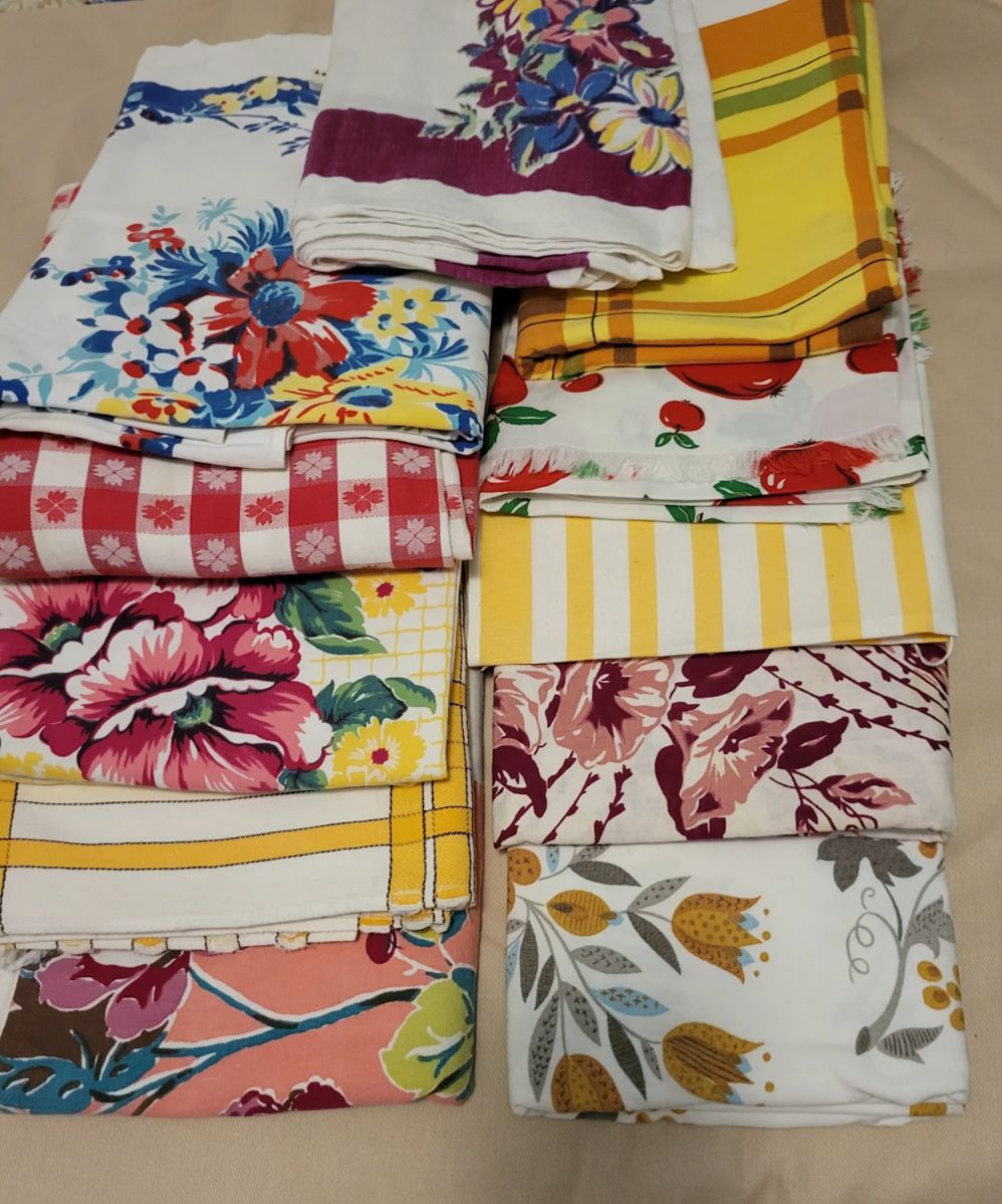 Great vintage table cloths, napkins, dish towels.  If you like vintage linens, we have SO MUCH!  Bark cloth, crochet doilies, handkerchiefs, chenille bedspreads, feedsack fabric, quilts, quilt tops, cut quilt pieces, quilt books, quilt patterns, feedsack dress, vintage children's clothing items...