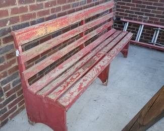 Long red bench, chipping paint, but very sturdy
