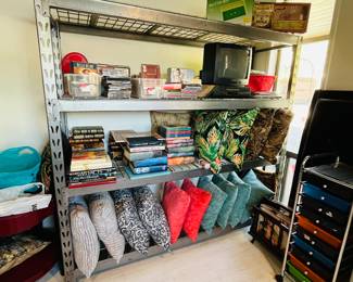 Love a big ol’ storage rack! This one filled with books, decorative pillows and CDs