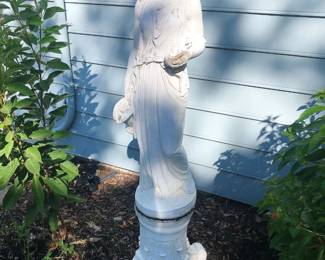 A wonderful collection of marble and cast stone statuary, fountains and urns throughout the grounds of this stately Sterling Heights home.