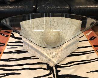 Post Modern tesselated stone coffee table with glass top.
