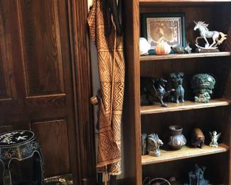 Life-size carved wood sculpture of Maasai warrior in traditional mud cloth dress.