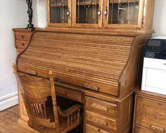 Vintage traditional oak roll top desk with slide-out keyboard table and fitted compartments.