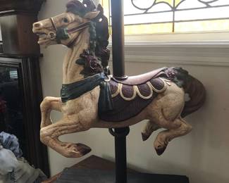 Reproduction miniature painted carousel horse on stand.