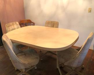 MCM Formica top table and 4 rolling chairs.  Table is in great shape, 64” long with a leaf.  Remove, it’s round.  Chairs need deep clean or reupholstered.  Sturdy, but very soiled.