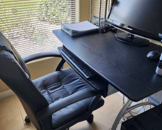 Very nice black leather desk chair with beautiful black wood grained desk.  Both are in excellent condition.