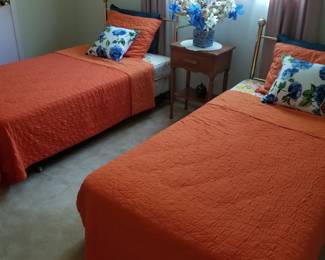 Twin beds with brass headboards