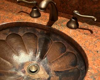sink detail - 60" wide marble vanity with copper sink.