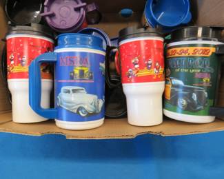 Lot 32: 12 Back to the 50's insulated mugs and three Disney Coke mugs