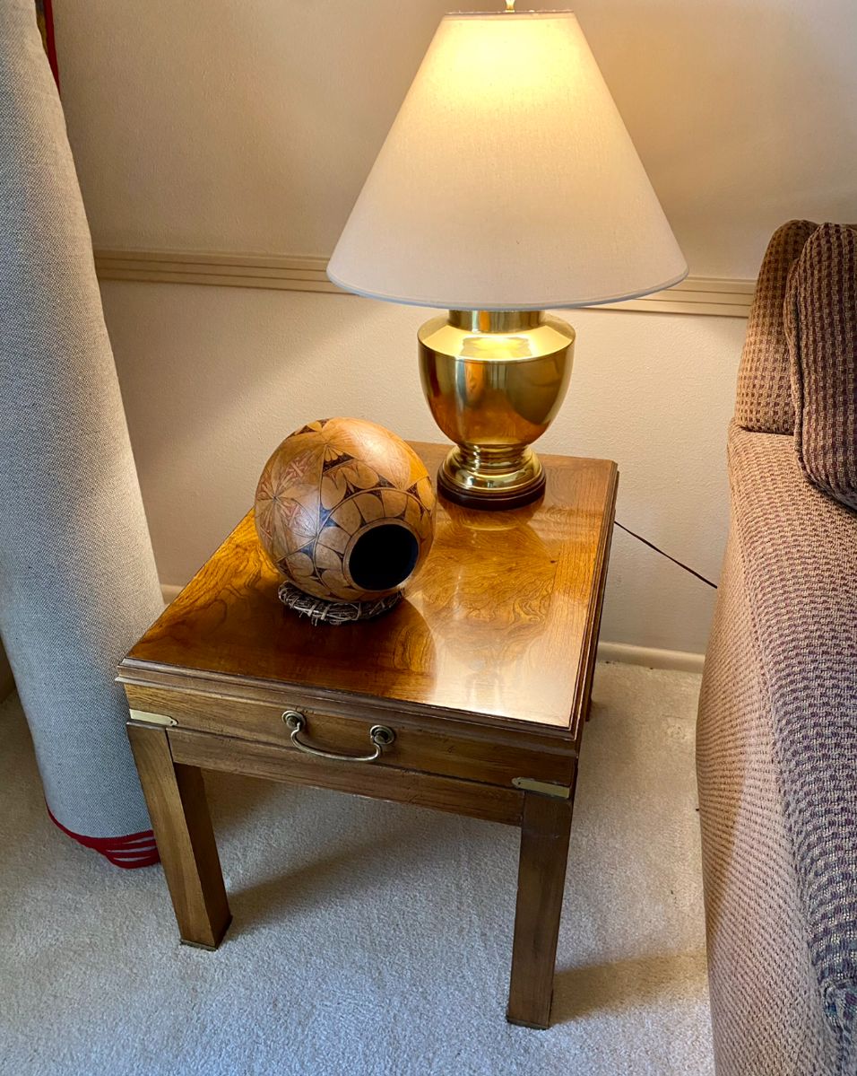 we have two end tables, with brass accents and two brass lamps, 1 of 2