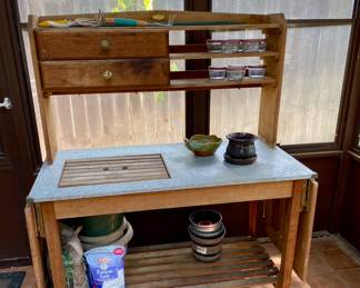 wonderful potting table with fold out sides , galvanized work area 